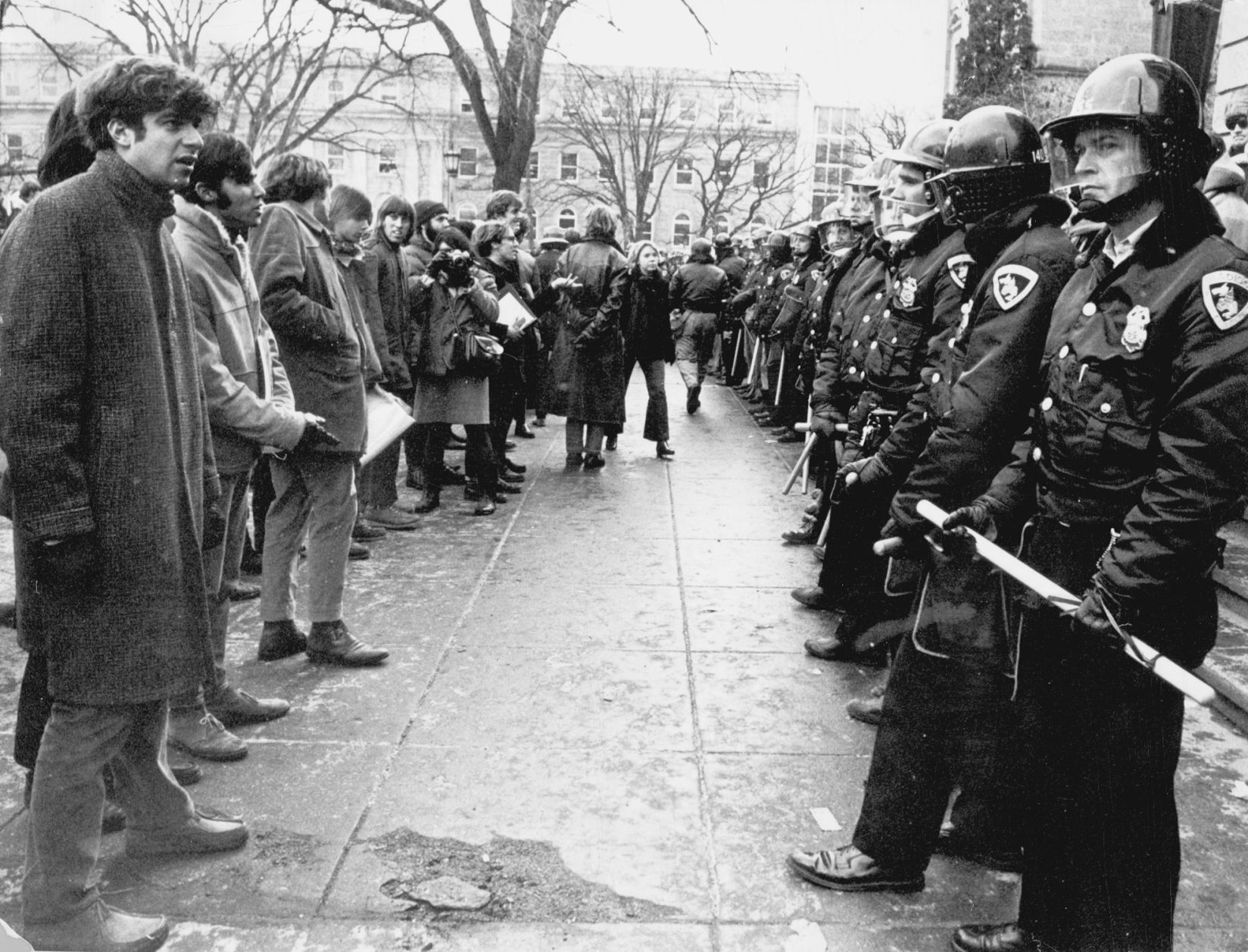Students confront riot police